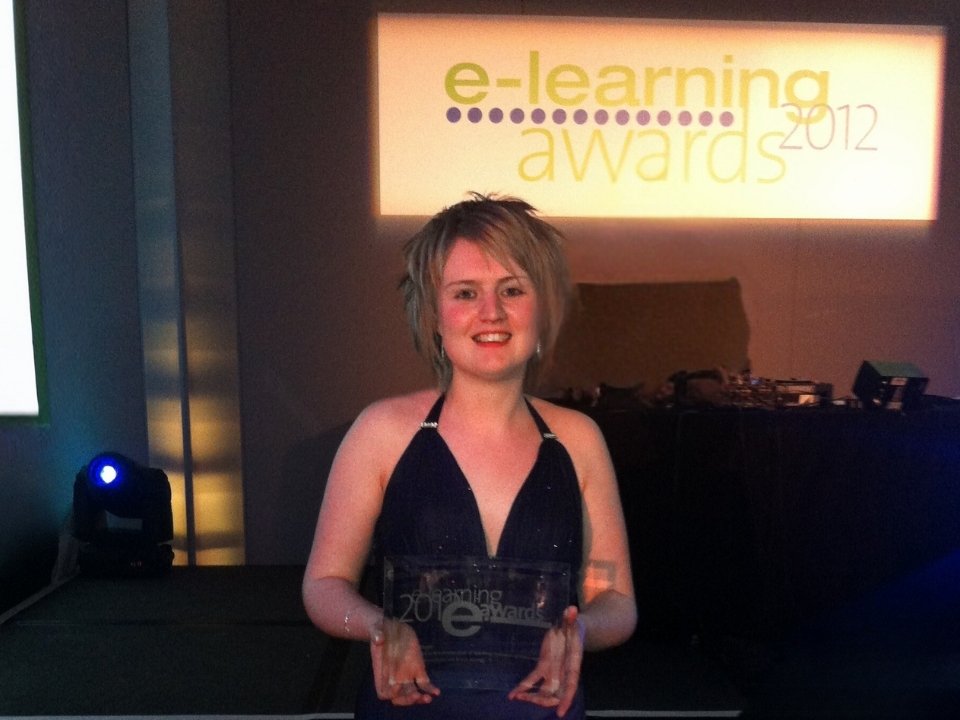 emily holding an award at e-learning awards in 2012