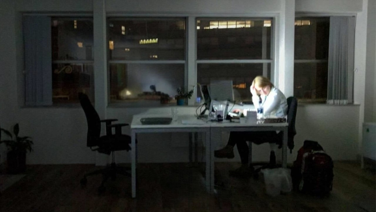 Emily working late in dark office