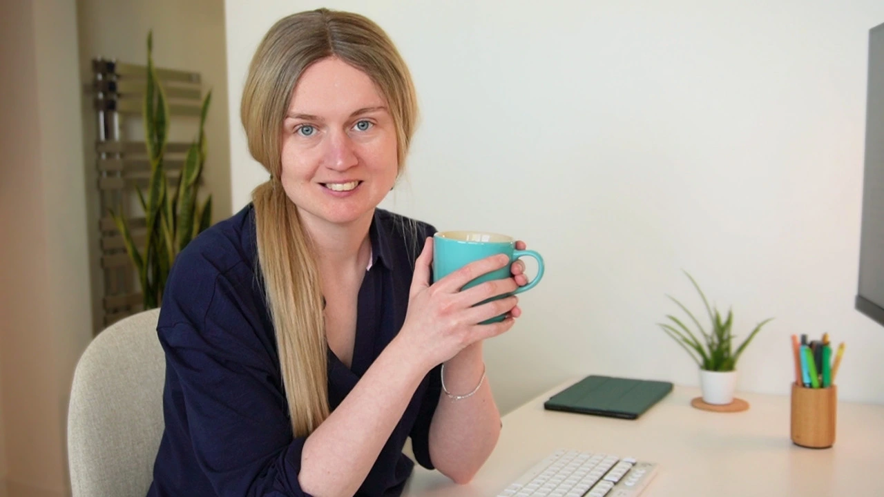 emily at her desk with a cup of tea